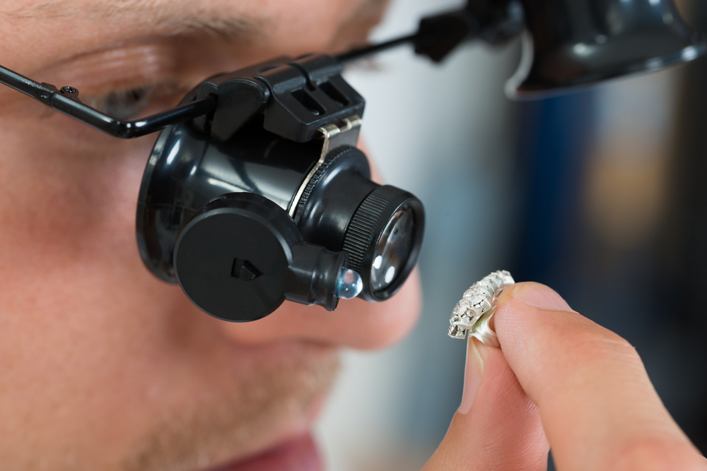 Close-up Of Jeweler Looking Ring Through Magnifying Loupe(Andrey_Popov)S