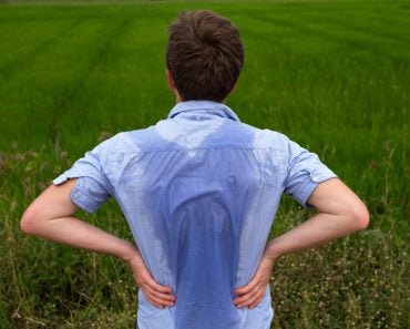 Man with hyperhidrosis sweating very badly under armpit in blue shirt because of hot weather(Koldunova Anna)s