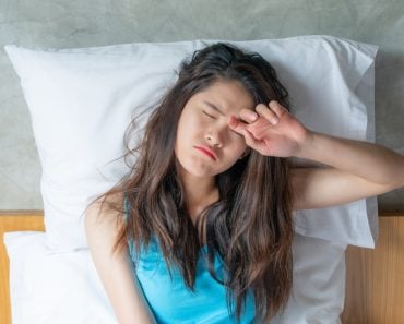 Portrait of young Asian woman feeling sleepy and tired after sleepless night(Boyloso)s