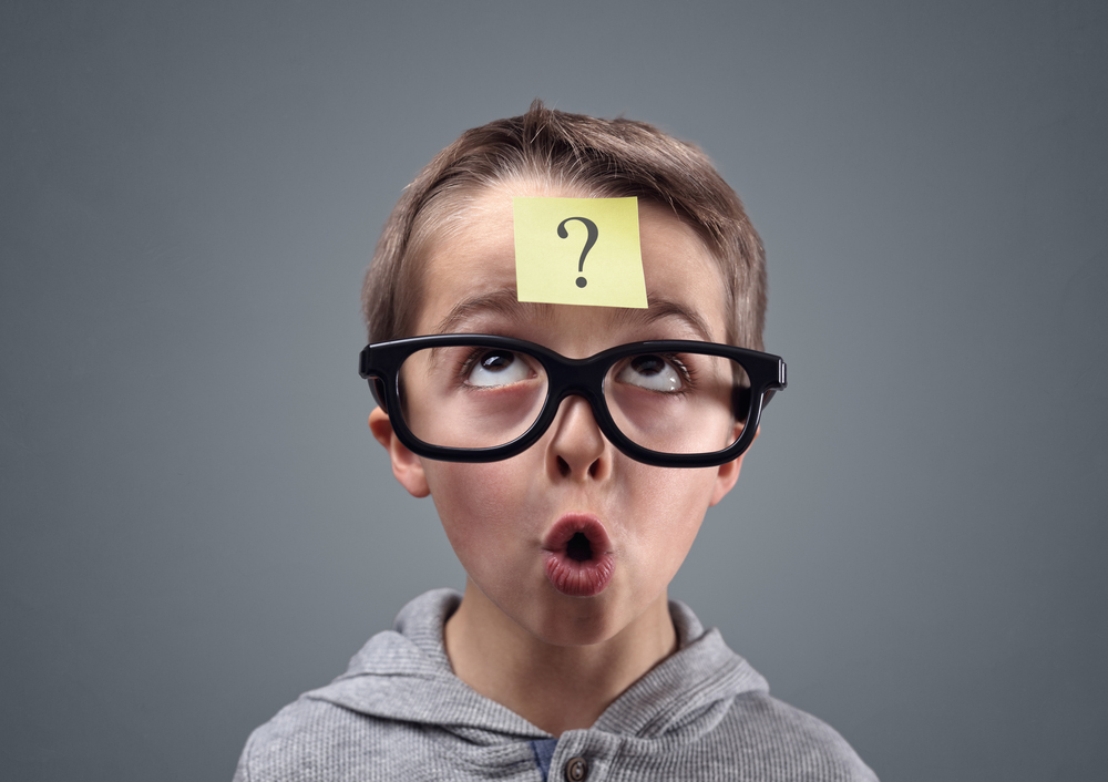 Confused boy thinking with question mark on sticky note on forehead(Brian A Jackson)s