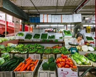 One elderly woman working at a greengrocery store inside the wet market in Chinatown, Singapore(Filipe.Lopes)s