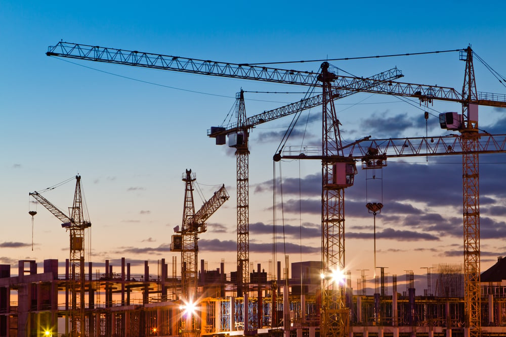 Silhouettes of tower cranes against the evening sky. House under construction. Industrial skyline(Oleg Totskyi)s