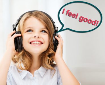i feel good image, home, technology and music concept - little girl with headphones at home