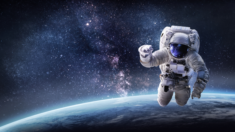 Astronaut in outer space over the planet Earth(Dima Zel)s