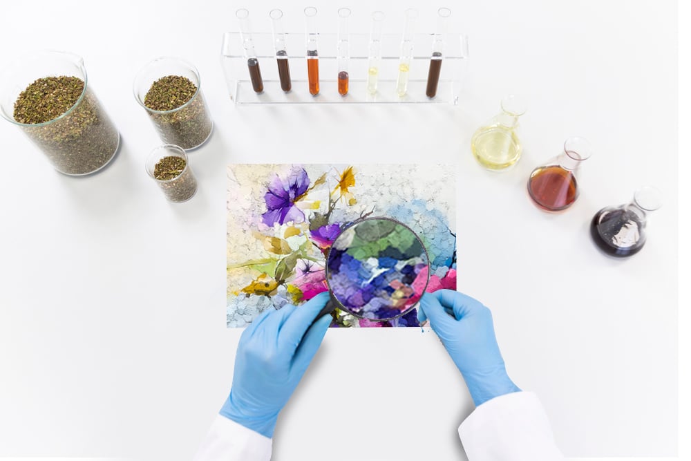 Scientist with a magnifying glass taking a look at a painting