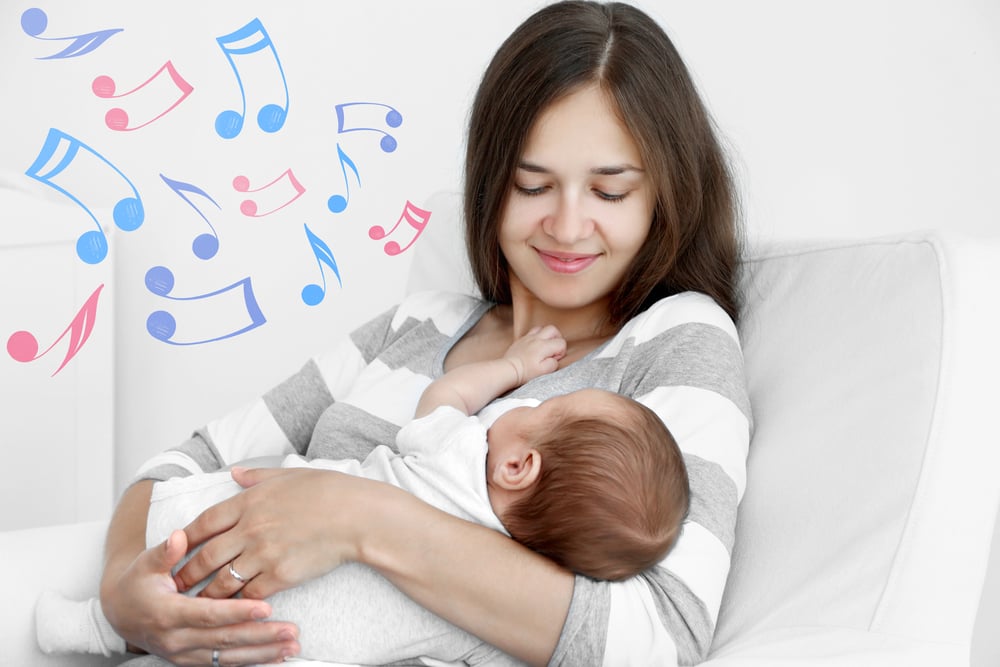 Mother with sleeping baby sitting in armchair(Africa Studio)s