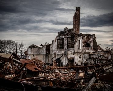 Wide angle shot of a dramatic and gloomy photo of a collapsing vintage brick industrial building left abandoned(R. Wellen Photography)s