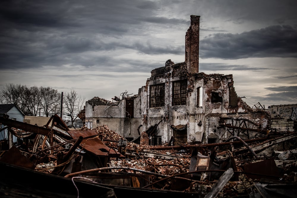 Wide angle shot of a dramatic and gloomy photo of a collapsing vintage brick industrial building left abandoned(R. Wellen Photography)s