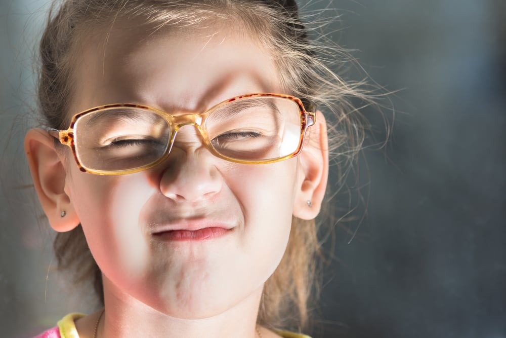 Beautiful child with glasses squinting from the light(Tagwaran)s