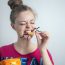 Smiling,Young,Caucasian,Woman,Girl,Eating,Biting,Potato,Chips,Crisps