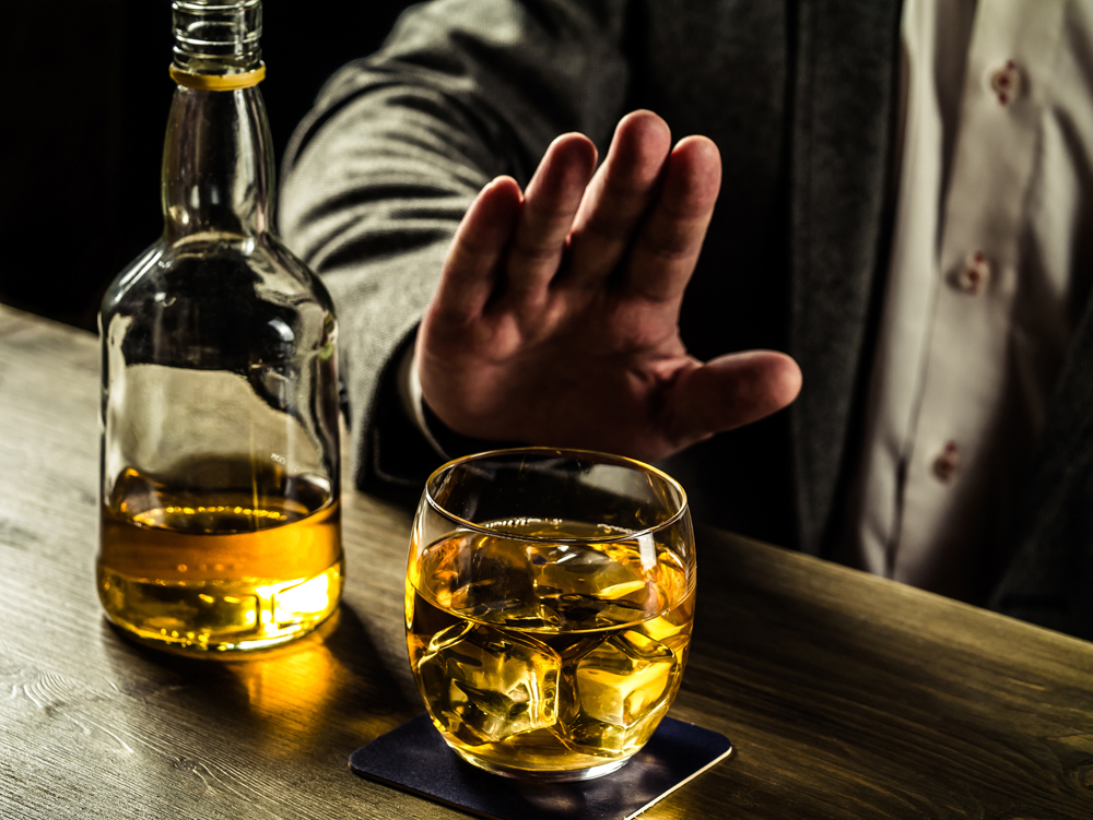 Man saying no more to alcohol with his body language