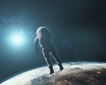 Astronaut against realistic planet Earth starlight. Back view of spaceman in outer space illuminated mainland surface. 3d animation. Science and technology. Elements of this media furnished by NASA.