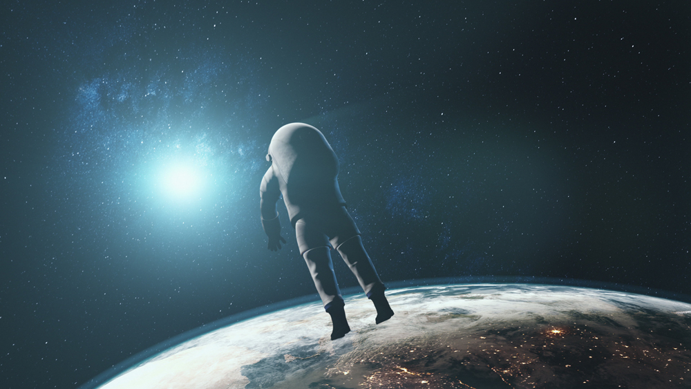 Astronaut against realistic planet Earth starlight. Back view of spaceman in outer space illuminated mainland surface. 3d animation. Science and technology. Elements of this media furnished by NASA.