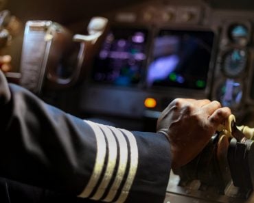 Cropped,Hands,Of,African,Pilot,Flying,A,Commercial,Airplane,,Cockpit