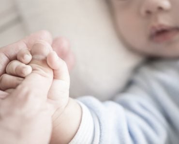 Little,Newborn,Baby,Holding,Parent's,One,Hand,,Close-up,Macro,Shot.