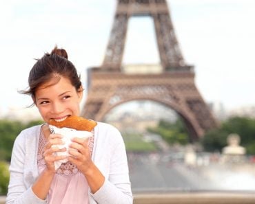 Paris,Woman,Eating,Pancake,In,Front,Of,Eiffel,Tower,,Paris,