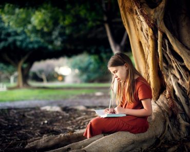 Cute,European,Kid,Girl,In,Dress,Sits,And,Study,Near