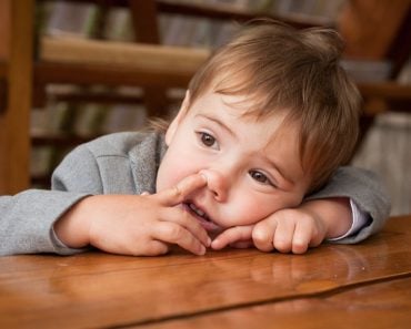 Little,Baby,Boy,With,Finger,In,His,Nose