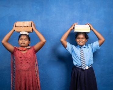 Two,Girl,Kids,With,Books,And,Bricks,On,Each,Other