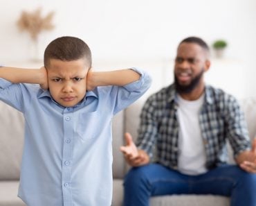 Black,Boy,Covering,Ears,While,Angry,Father,Shouting,At,Him