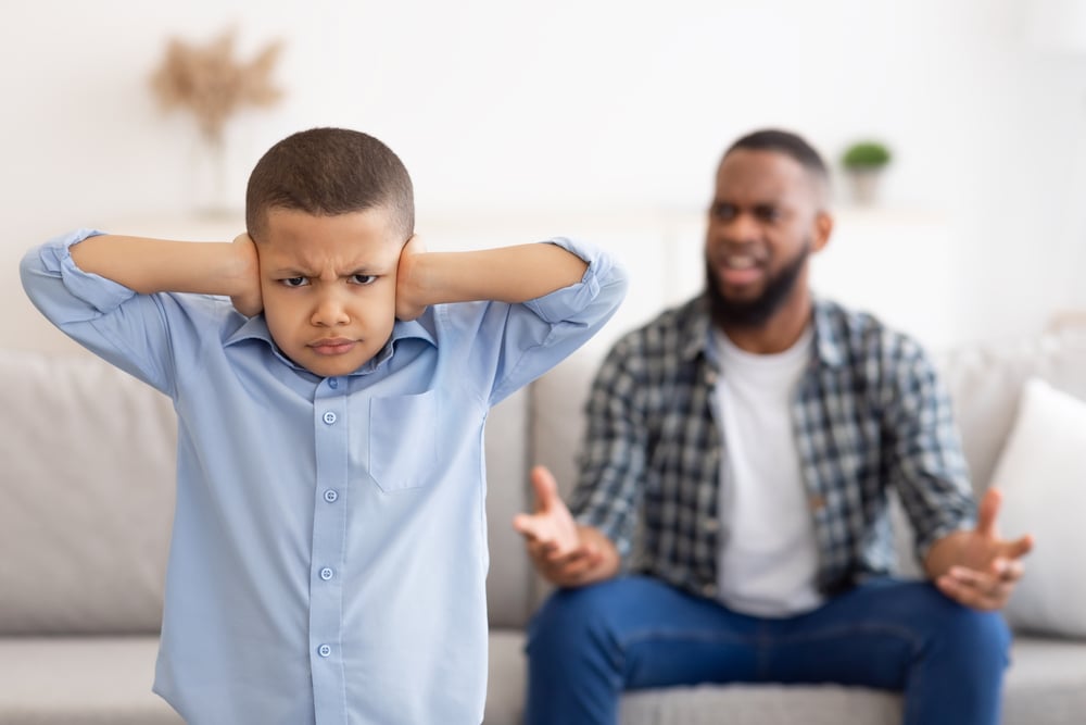 Black,Boy,Covering,Ears,While,Angry,Father,Shouting,At,Him