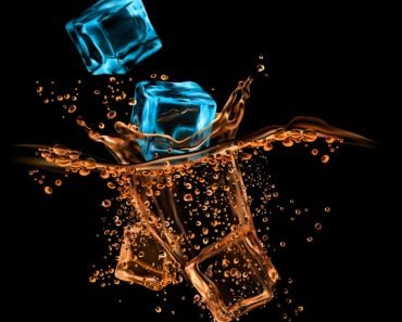 Ice-crystal-cubes-falling-to-whiskey-cognac-or-rum-bourbon-or-brandy-alcohol-drink