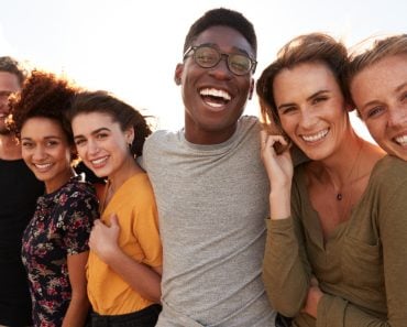 Portrait,Of,Smiling,Young,Friends,Walking,Outdoors,Together