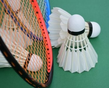 White,Cream,Badminton,Shuttlecocks,,Badminton,Rackets,On,Green,Floor,Of