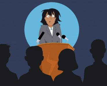 Terrified female speaker on a stage in front of the audience