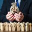 Businessman,Holds,Out,A,Dollar,Money,Bag,To,The,Crowd.