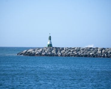 Landscape,With,A,Green,Lighthouse,On,A,Breakwater,On,The
