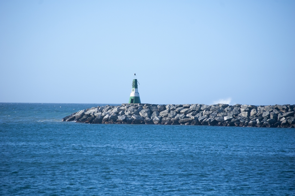 Landscape,With,A,Green,Lighthouse,On,A,Breakwater,On,The