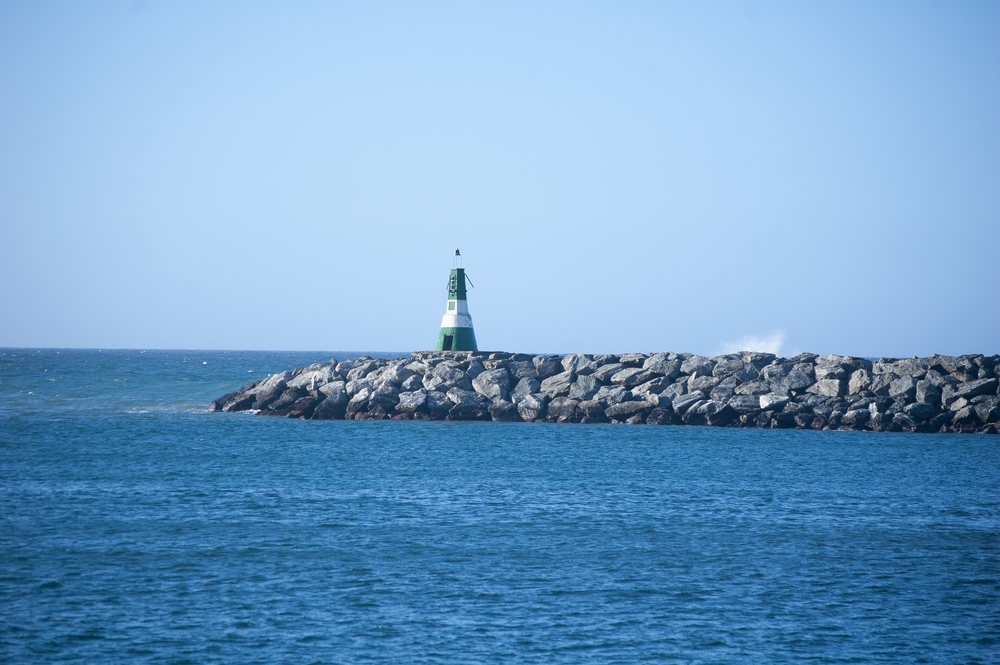 Landscape,With,A,Green,Lighthouse,On,A,Breakwater,On,The