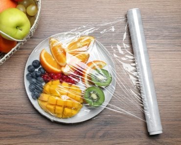 Plate,Of,Fresh,Fruits,And,Berries,With,Plastic,Food,Wrap