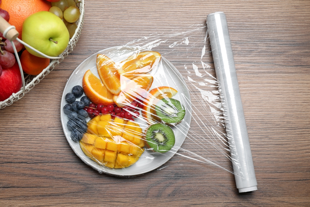 Plate,Of,Fresh,Fruits,And,Berries,With,Plastic,Food,Wrap