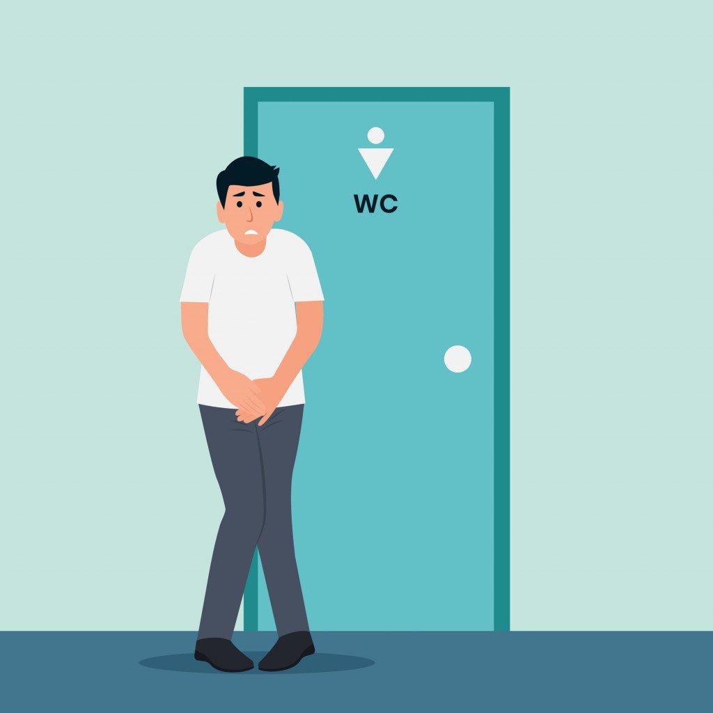 Stressed man standing standing at the closed toilet door