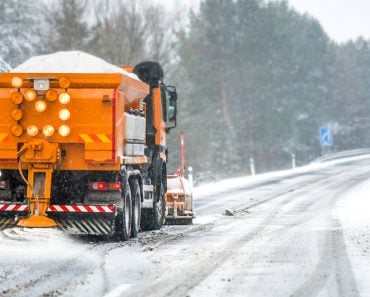 Snow,Plow,On,Highway,Salting,Road.,Orange,Truck,Deicing,Street.