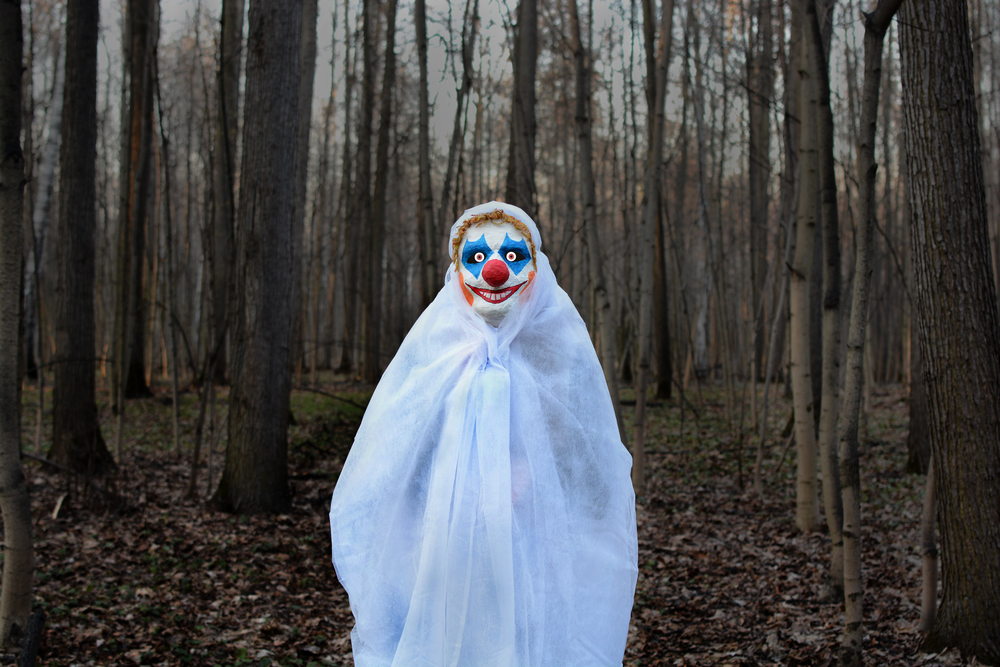 Evil,Clown,In,A,Mask,Standing,In,A,Dark,Forest