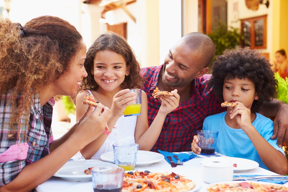 Family,Eating,Meal,At,Outdoor,Restaurant,Together