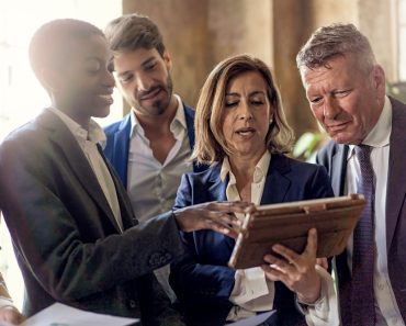 Five,People,Of,Different,Ethnicities,Stand,In,A,Modern,Office,