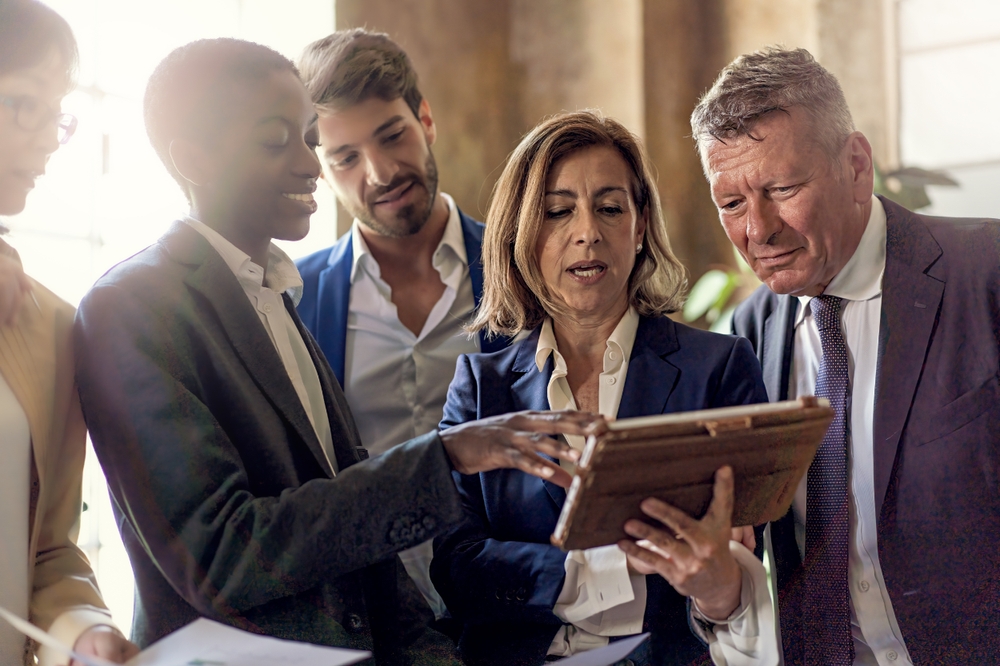 Five,People,Of,Different,Ethnicities,Stand,In,A,Modern,Office,