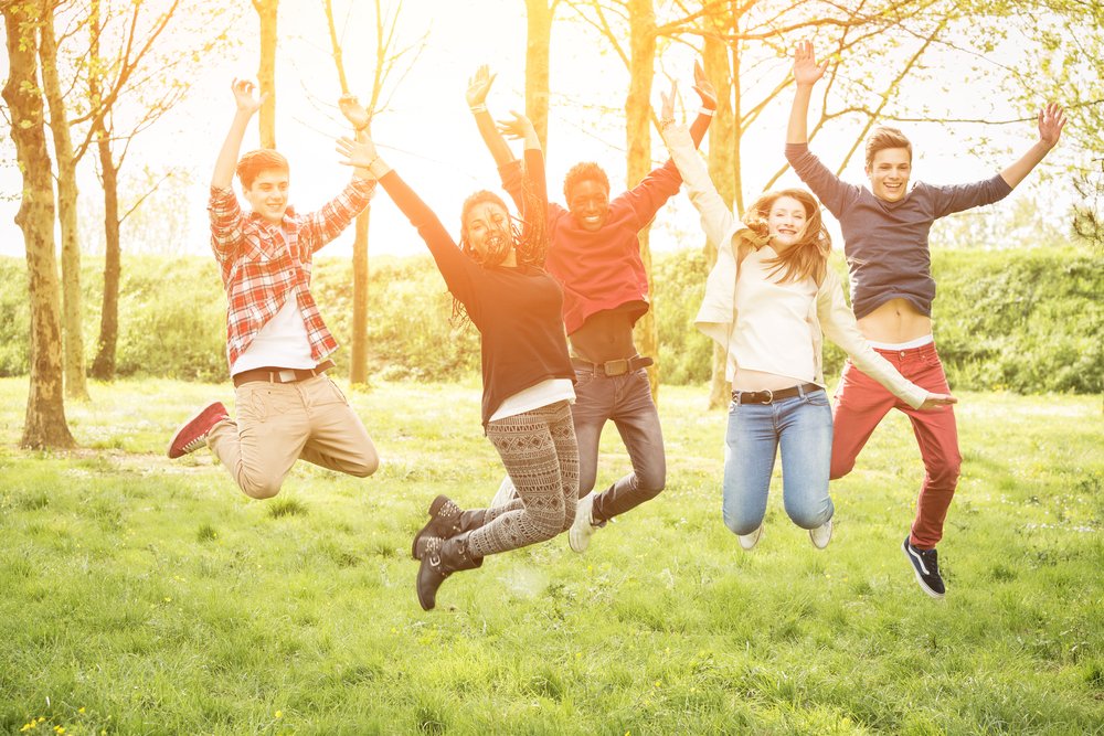 Teenagers Jumping Together