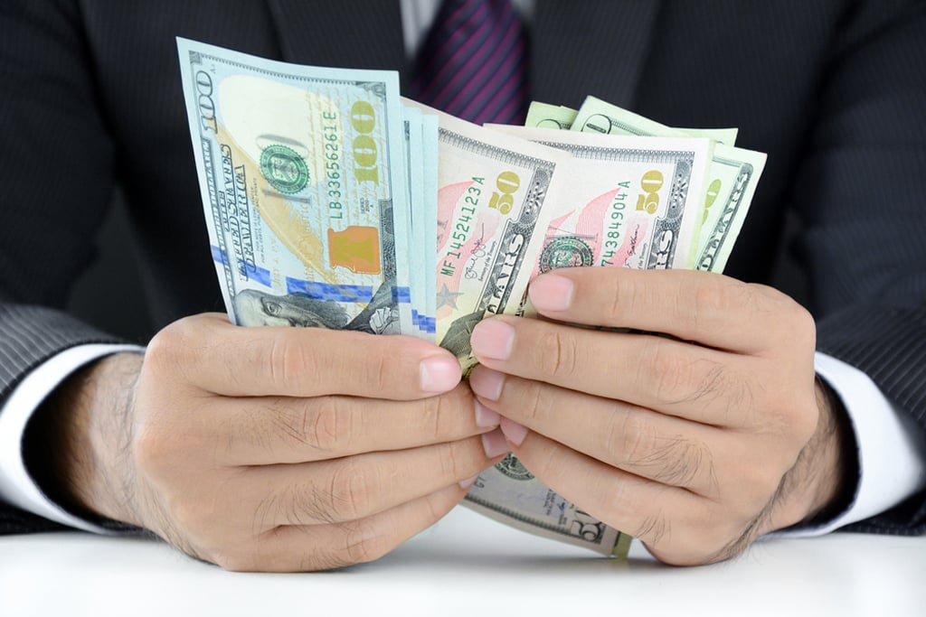 Businessman counting money,US dollar (USD) bills, on the table - soft focus(Atstock Productions)s