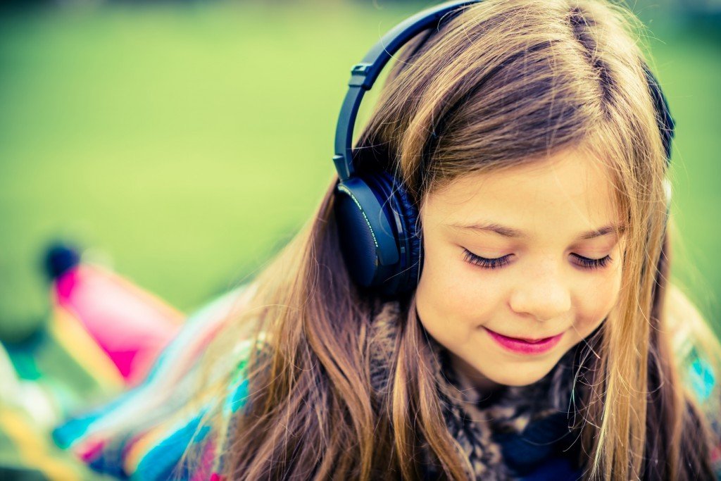 girl listening to music on headphones