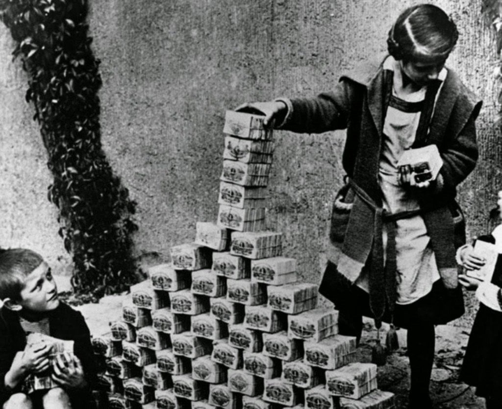 A young girl in Germany playing with what seems to be bundles of money