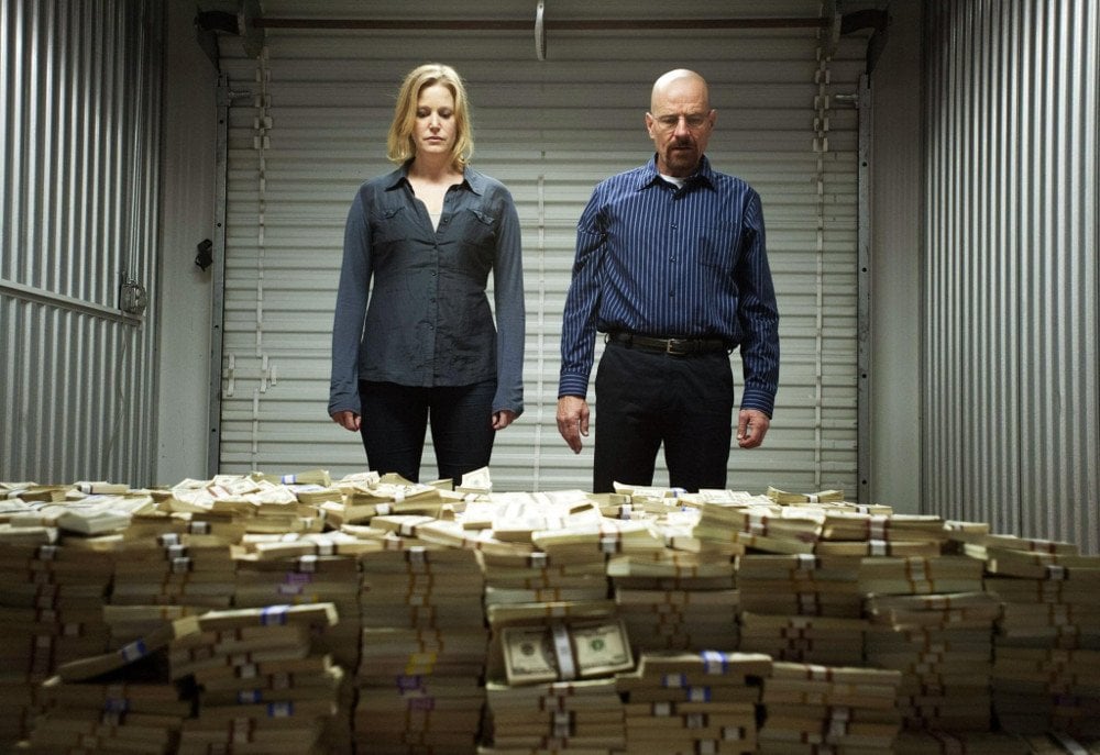 Breaking bad scene where Walter White and Skylar stand in front of a huge pile of cash
