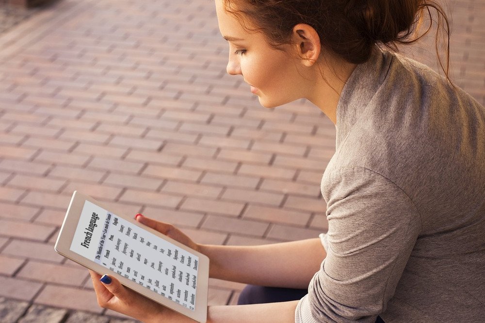 Girl learning language on tablet