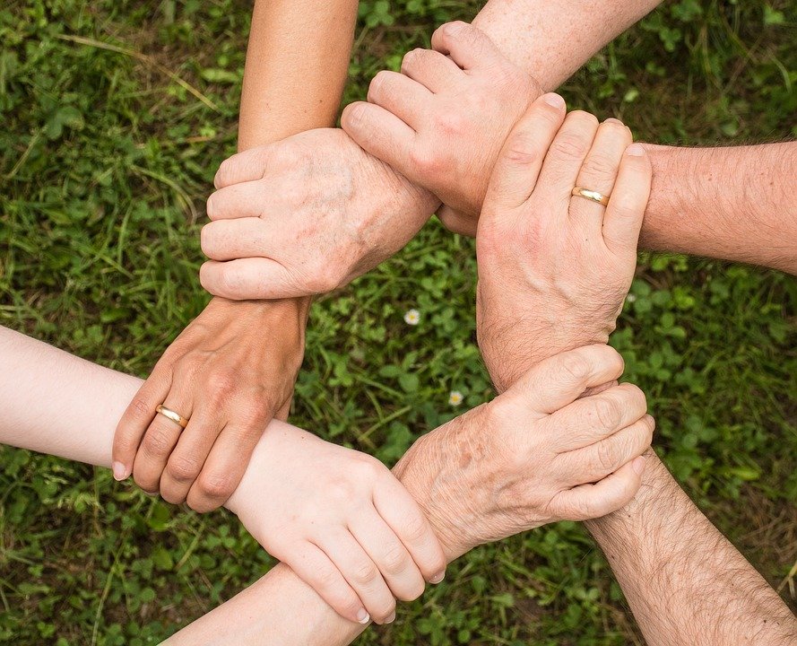 people holding hands races fingers