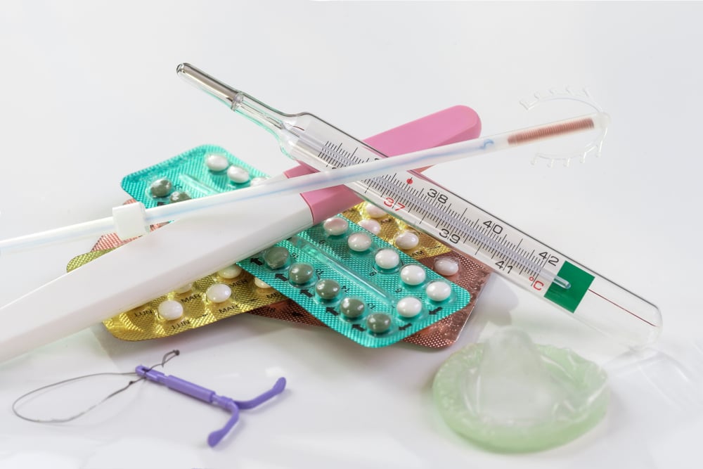 condoms and birth control pills on a white background(JPC-PROD)s