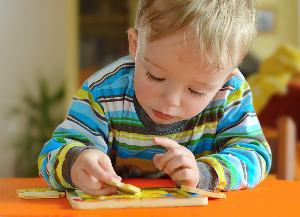 Little toddler doing puzzle. Boy learns to solve problems and develops cognitive skills and . Child concept. - Image(Sasenki)S